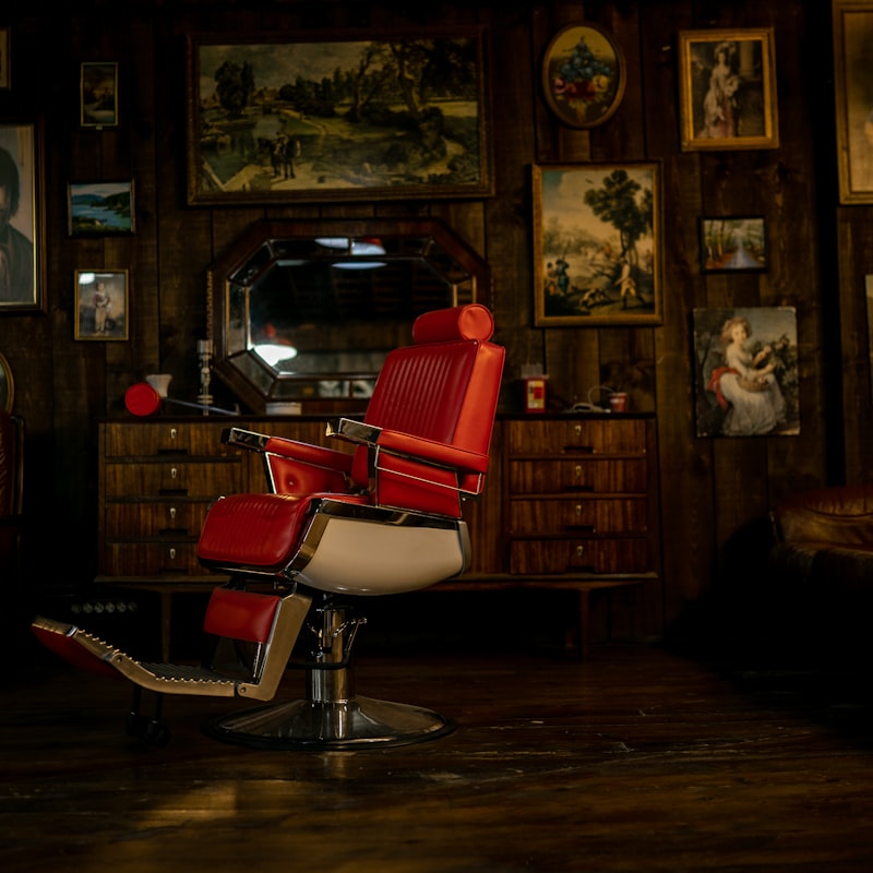 Red leather barber chair in a wood-panelled shop