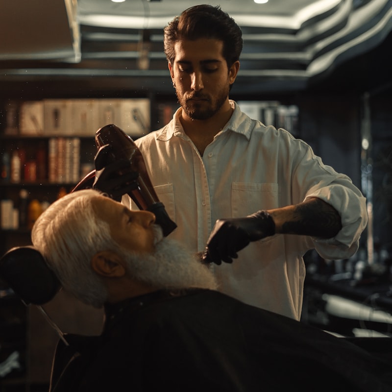 Barber trimming a client’s beard