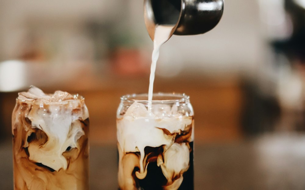 Cream poured into iced coffee