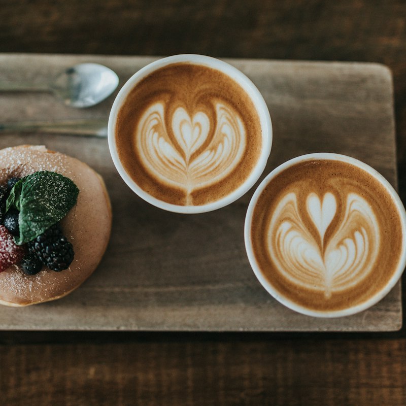 Two white mugs on wooden boards