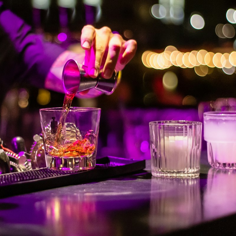A drink being poured at the bar